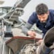 Global manufacturing specialization - aerospace engineer working on precision aircraft components representing America's manufacturing expertise