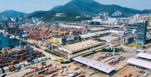 Aerial view of integrated global manufacturing hub showing container port, logistics facilities, and supply chain infrastructure demonstrating the concentrated networks that accelerate production cycles in offshore manufacturing