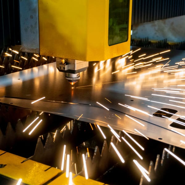 Precision laser cutting in contract manufacturing facility, showcasing capability-matched production for custom metal components.